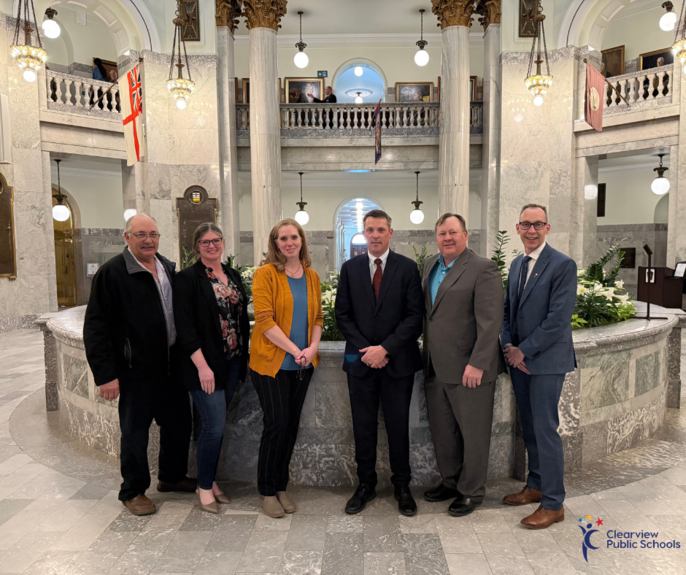 Clearview Public Schools representatives pose with MLA Nate Horner inside the Alberta Legislature building. Pictured from left to right: Trustee John Schofer, Trustee Shauna-lee Thomas, Trustee Becky Scott, MLA Nate Horner, Board Chair Guy Neitz, and Supe