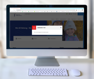 A screenshot of Clearview Public Schools' website with an emergency test message displayed on the screen. The message reads, 'EMERGENCY TEST: This is a test message of our broadcast system.' The website is open on a desktop computer with the main page vis