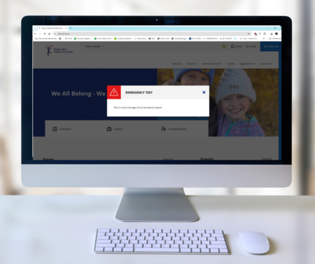 A screenshot of Clearview Public Schools' website with an emergency test message displayed on the screen. The message reads, 'EMERGENCY TEST: This is a test message of our broadcast system.' The website is open on a desktop computer with the main page vis